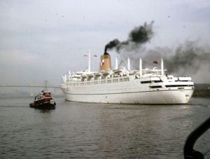 Photo of the Empress of England arriving in the Port of Montreal from the Archives de la Ville de Montreal on Flickr. (Navire «Empress of England» escorté par un remorqueur, 1963, VM94-AD-5-056)